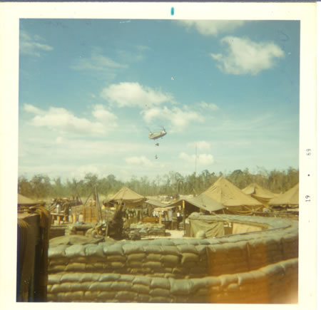 Gela_1969_-_Resupply_chopper_with_mail_and_ammo_each_day.__Carrying_water_trailer._fs